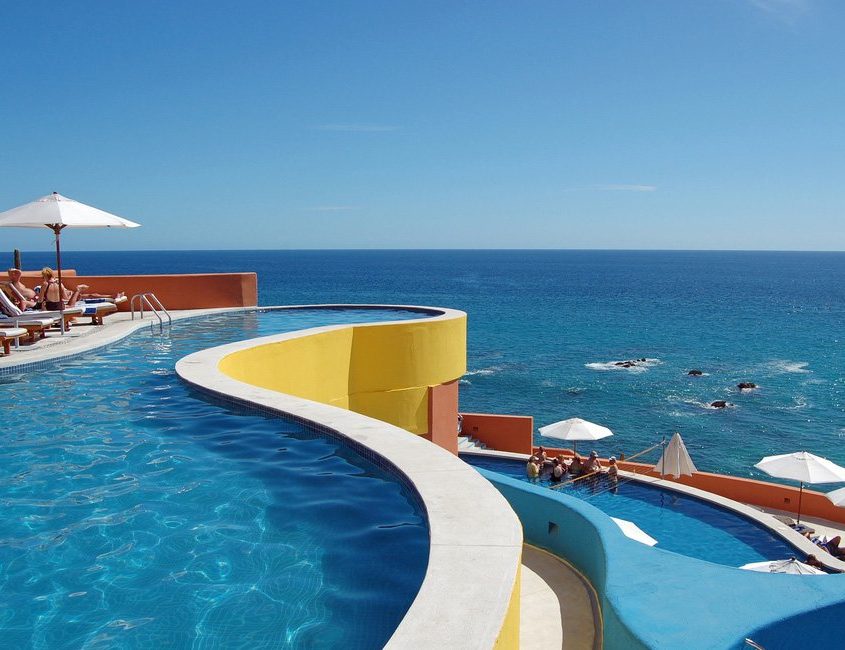landscape view of a three tiered pool looking out over the Caribbean sea