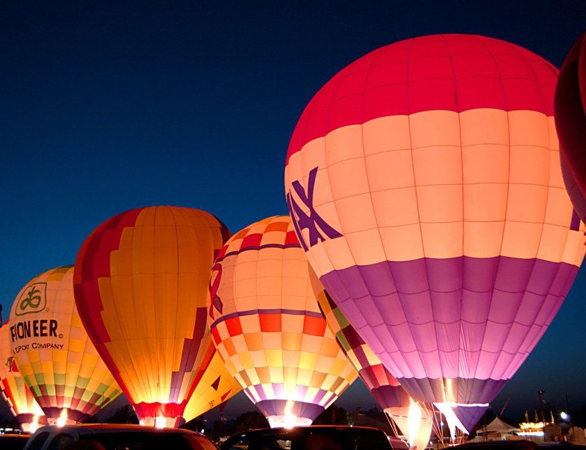 Hot air balloons for various companies at night
